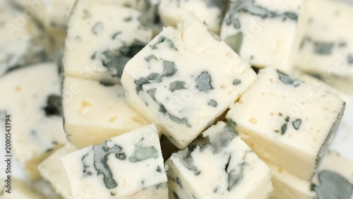 Blue cheese. Heap of sliced blue cheeses with a noble mold