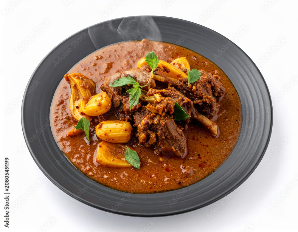 Fototapeta premium Shivamogga Mutton Jackfruit Seed Curry On Denim Blue Plate Isolated On White Background