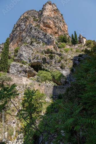 Notre-Dame de Beauvoir Chapel Beneath Towering Limestone Cliffs in Moustiers-Sainte-Marie, Provence, France.