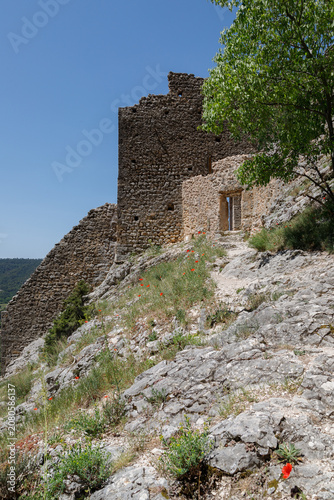 Ancient Castle Ruins on a Rocky Hillside Under a Clear Blue Sky in Provence, France.