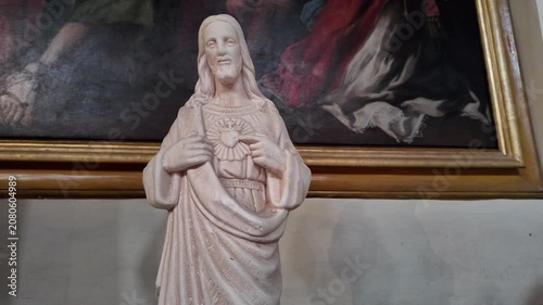 Cinematic View Of A White Statue Of The Sacred Heart Of Jesus In A Roman Church