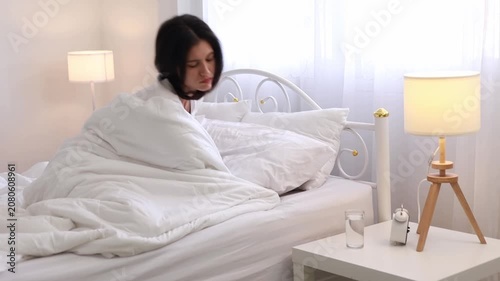A woman waking up and drinking plain water for good health in the morning. A health-conscious idea.