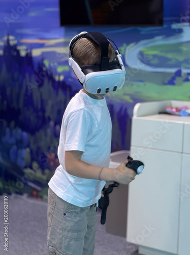 A boy in a white T-shirt wearing a virtual reality headset is playing a game.
