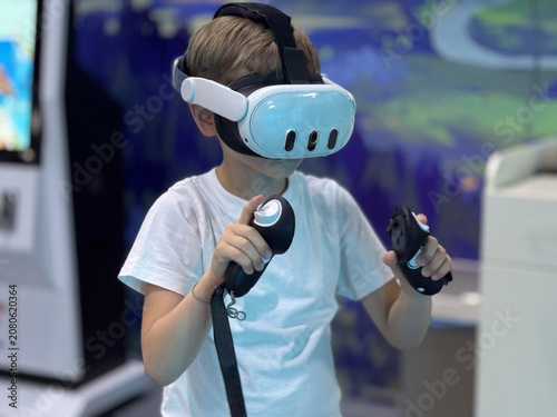 Curious child exploring virtual reality technology with VR headset and controllers in an entertainment center.
