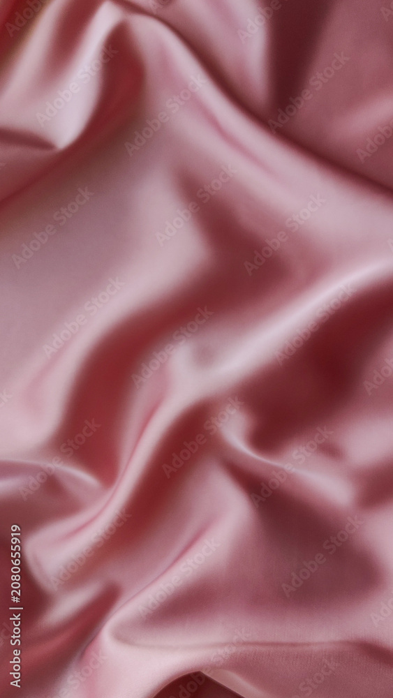 Fototapeta premium Pink satin fabric with soft folds and smooth glossy texture in close up. Elegant luxury textile background for fashion and home decor. Fabric texture, satin cloth, luxury background, minimal style.