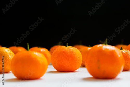 Fresh Mandarin Oranges on a black background