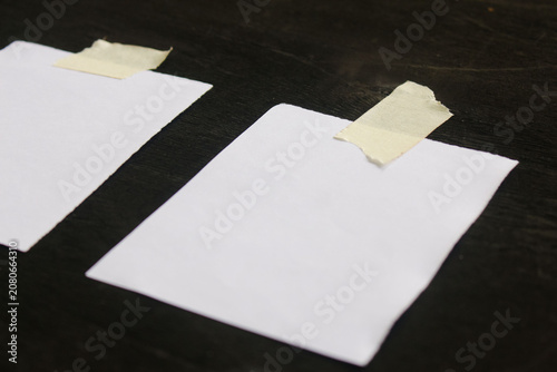 Small white paper note on black background
