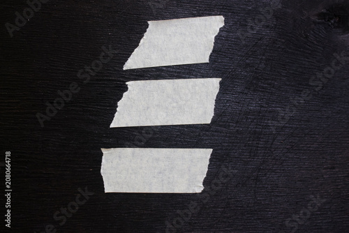 Paper plaster with some cuts on black background