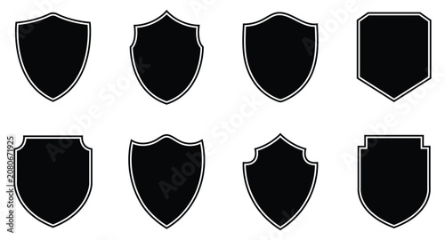 Collection of black shield icons with outlines for security, defense, or heraldic design elements on white background