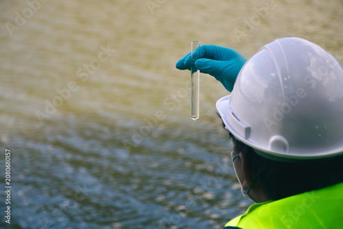 Quadro su tela Field technicians performing water sample collection for environmental testing and conservation