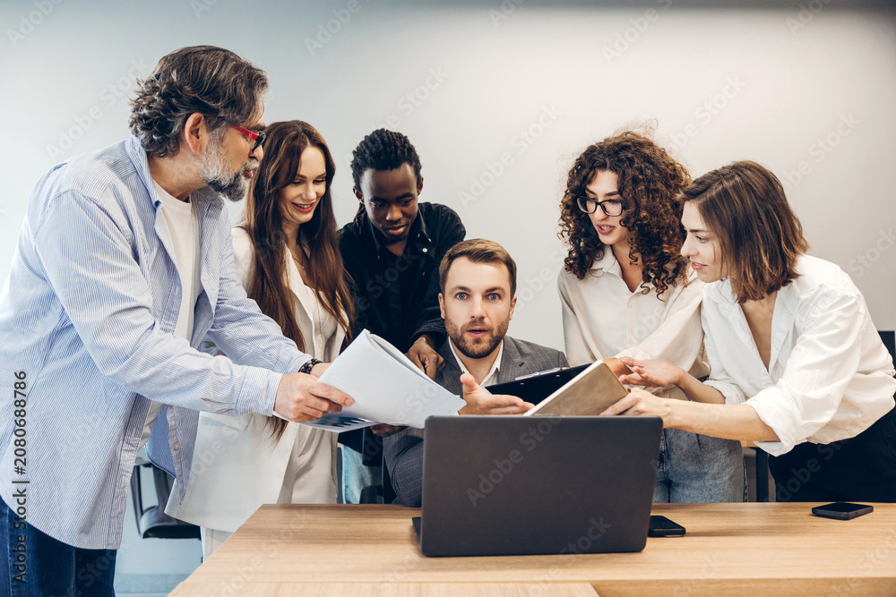 Fototapeta premium Diverse business team collaborating and discussing documents in office
