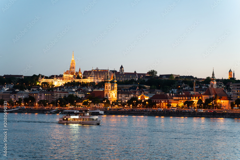 Fototapeta premium Illuminated Matthias Church and Buda skyline at blue hour twilight