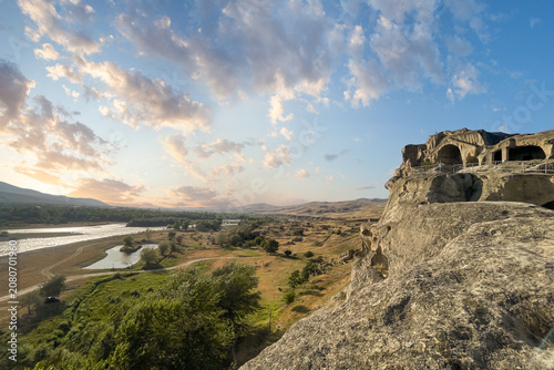Canvastavla Georgian landscape with Kura river sunset sky with cloud and famous Uplistsikhe