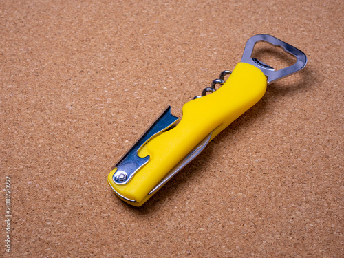 The tool includes a stainless steel corkscrew, a bottle cap lifter, and a foil cutter knife.