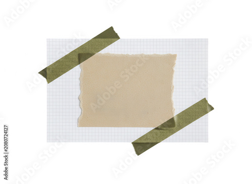 Fotografie Torn paper note with green tape on grid background