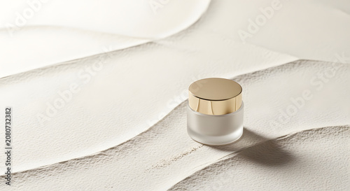 Luxurious frosted beauty cream jar with gold cap on sand