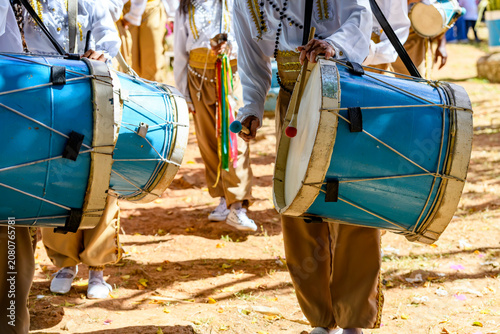 A group of people parading with their drums during the Congado festivities in Minas Gerais.