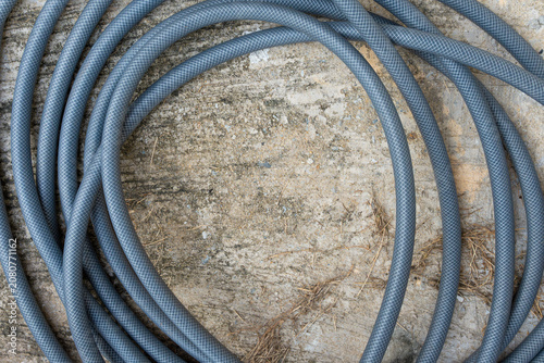 Gray hose on concrete in the garden.