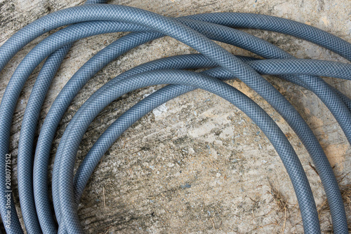 Gray hose on concrete in the garden.