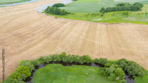 Aerial View of Meandering River and Farmland in Lithuania