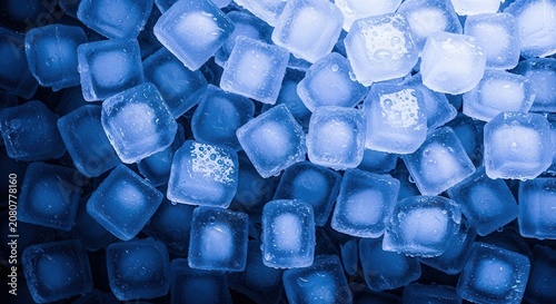 Clear ice cubes glowing with bright blue and purple neon lights in a dark room