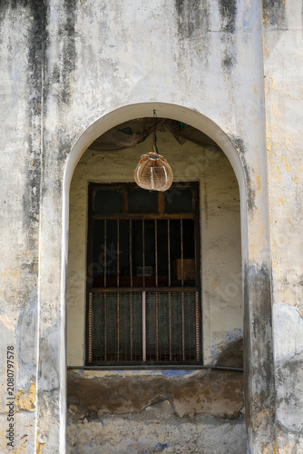 Historic arched window with weathered facade in George Town Penang Malaysia