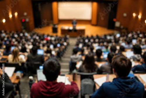 Large lecture hall with students using laptops
