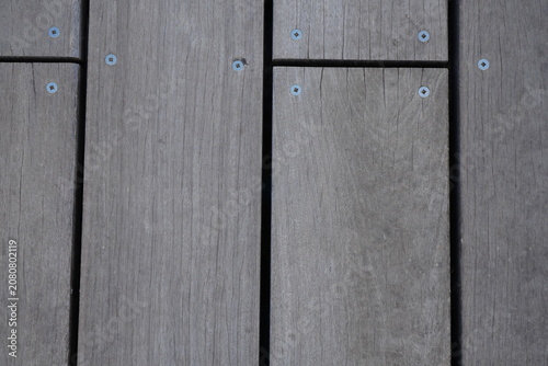 Photos Weathered wooden deck planks with visible grain and screw details