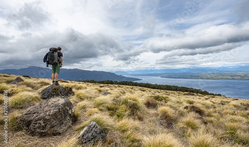 Hiker looks out over Lake Te Anau and Southfiord, Kepler Track, Fiordland National Park, Southland, South Island, New Zealand