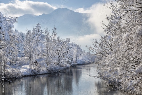Winter landscape with outflow of the Loisach from the Lake Kochel in front of the Herzogstand 1731m, Kochel am See, Das Blaue Land, Bavarian Alps, Upper Bavaria. Bavaria, Germany