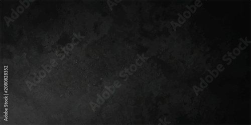 Textured black mottled stone abstract background, black stone slate with mottled grunge texture and subtle centre light, elegant backdrop for banner, presentation and cover.