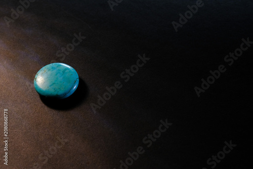 Blue Turquoise Gemstone on Black Background with Copy Space