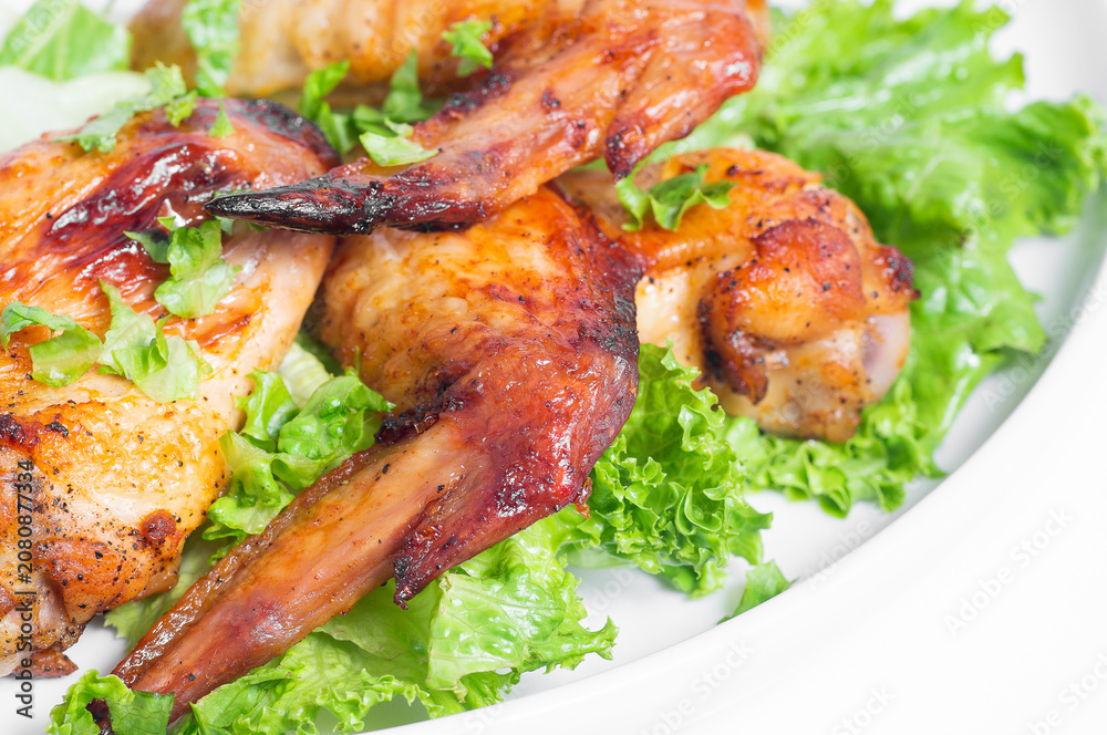 Fototapeta premium Fried chicken wings with herbs. Close-up.