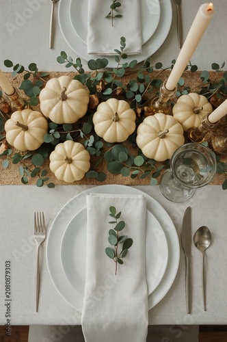 Table Set for a Meal With Pumpkins and Greenery in a Cozy Dining Space