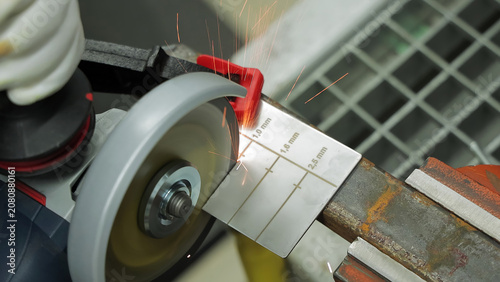 фотографія Angle Grinder Cutting Marked Metal Gauge