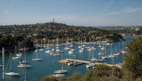 Sailboats Moored in a Harbor With a Hillside Town in the Background During a ...