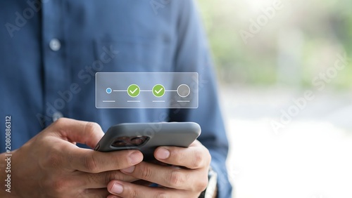 User hands interacting with digital progress bar and checkmark icons on mobile screen for process.