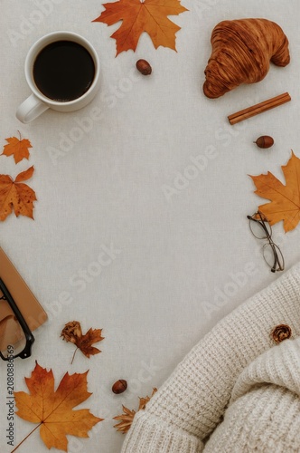 Warm Coffee and Pastries With Autumn Leaves on a Table in a Cozy Setting