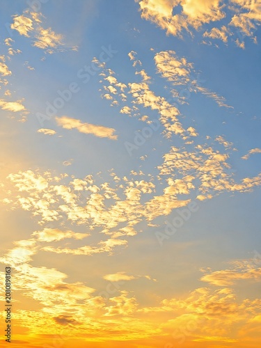 Golden hour sky background with soft clouds at sunset or sunrise, natural beauty of the heaven for abstract background and copy space.