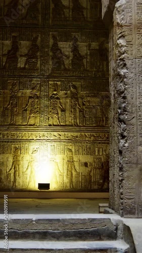 Ancient stone hall inside the Dendera Temple Complex with detailed hieroglyphic