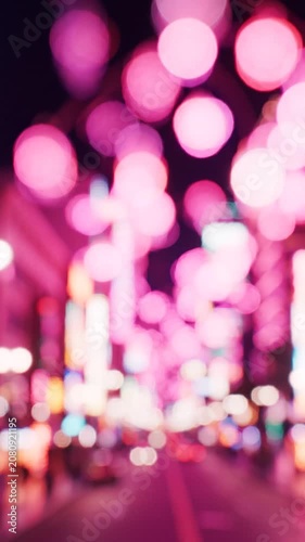 A Vibrant Night Scene with Blurry Neon Lights and Colorful Bokeh Effects Creating a Dreamlike Atmosphere in a Bustling Cityscape