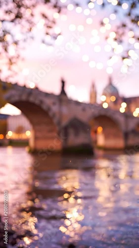 A serene twilight scene featuring a beautifully illuminated bridge reflecting on a calm river, surrounded by sparkling lights and a softly blurred background.