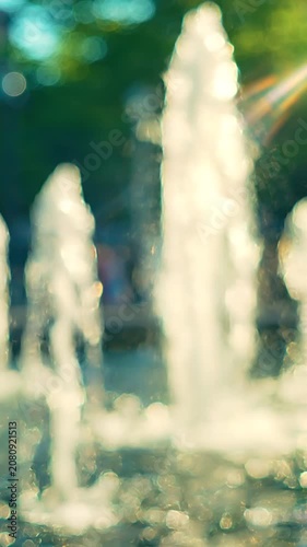 A Captivating Display of Water Fountains in Motion, Showcasing the Beauty and Charm of Water Elements Against a Blurred Natural Background