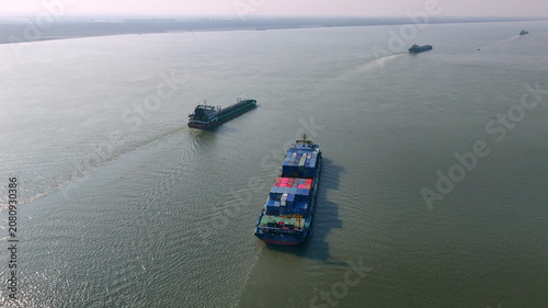 Fotografie Cargo Ships on a Wide River