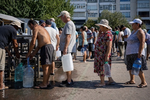 Community endures sweltering summer seeking vital water in urban relief line