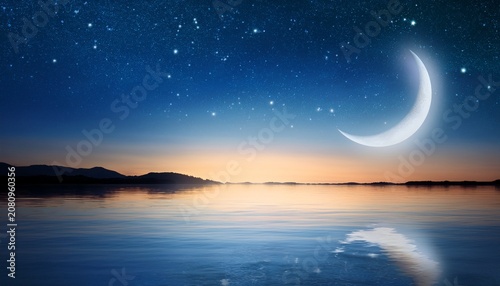 serene night sky over tranquil waters with a crescent moon and brilliantly shining stars