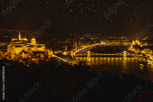 Bild auf Leinwand Cinematic night panorama of Budapest under a starry sky with illuminated Buda Ca