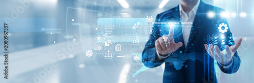Photography Business manager hand touching enterprise resource planning interface to integrate core processes, manage supply chains and centralize data for efficient corporate resource management today