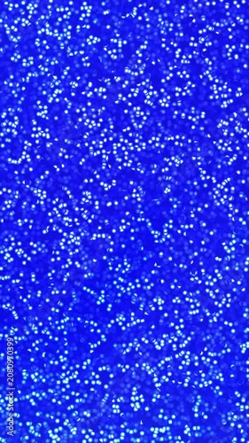 Vertical Sparkling blue background with bright shiny glitter texture and tiny white reflective light dots suitable for design projects, invitations, and backgrounds.