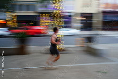 Slika na platnu A man running in downtown Raleigh, North Carolina
